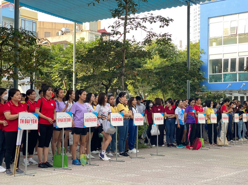 A group of people holding signs
Description automatically generated