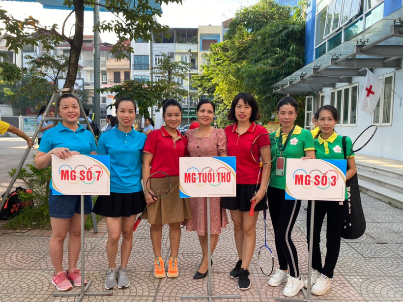 A group of people holding signs
Description automatically generated